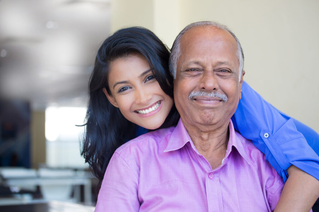 Closeup,Portrait,,Family,,Young,Woman,In,Blue,Shirt,Holding,Older