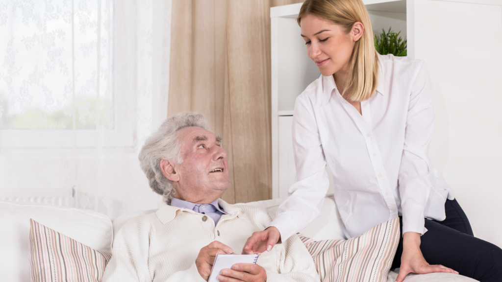 Family caregiver assisting an elderly loved one at home, helping with daily activities like bathing, medication, and meals, illustrating a structured caregiving routine for safety, independence, and emotional support.